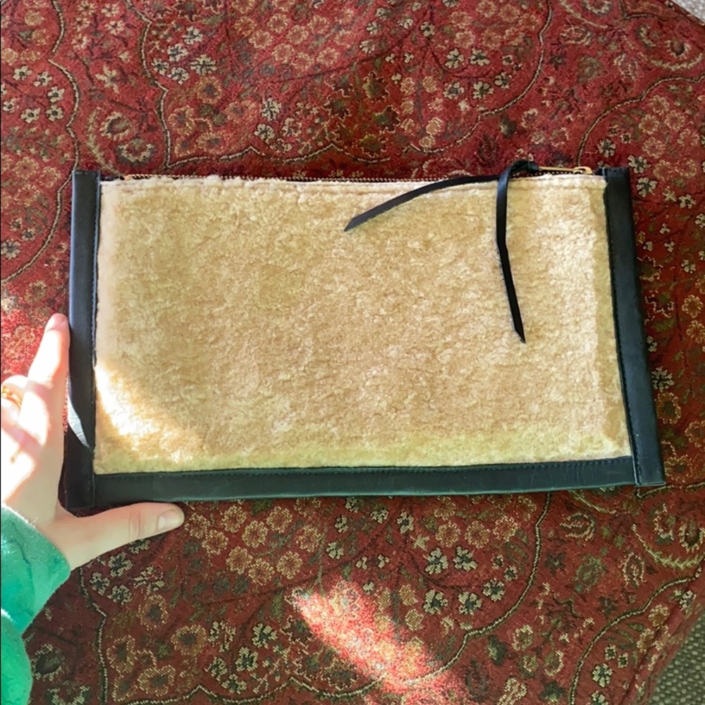 Sherling pouch with leather trim.